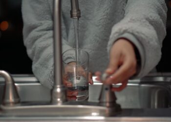 Mujer llenando vaso de agua